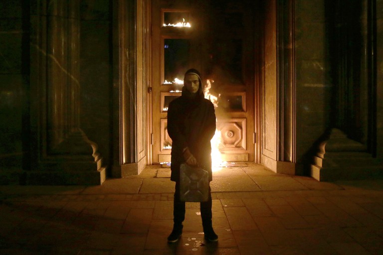 Russian artist Pyotr Pavlensky poses after setting fire to the doors of the headquarters of the FSB security service the successor to the KGB in central Moscow early today. Russian authorities detained a performance artist best known for nailing his scr