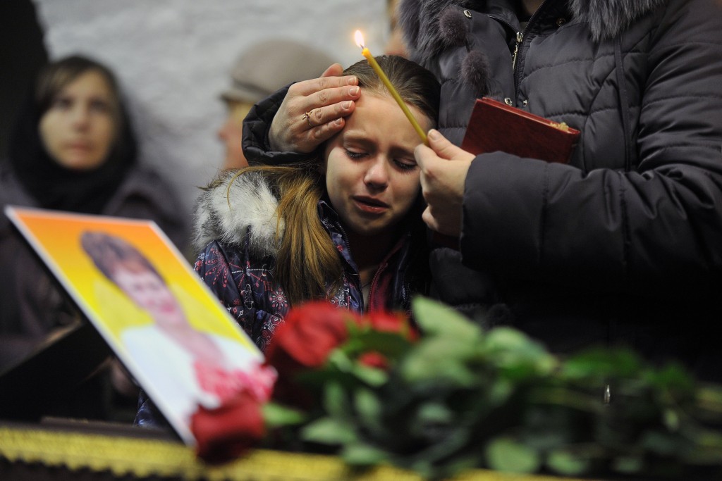 A girl cries during a funeral service for Nina Lushchenko 60 a victim of the Russian Metro Jet Airbus A321 crash at a church in Veliky Novgorod