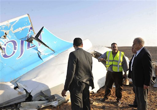 In this image released by the Prime Minister's office Sherif Ismail right looks at the remains of a crashed passenger jet in Hassana Egypt Friday Oct. 31 2015. A Russian aircraft carrying 224 people including 17 children crashed Saturday in