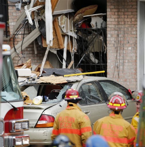 Officials respond to the scene of a house explosion Wednesday Nov. 11 2015 in Elizabeth N.J. The blast leveled the two-family duplex