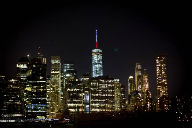 The One World Trade Center spire is lit blue white and red after New York Gov. Andrew Cuomo announced the lighting in honor of dozens killed in the Paris attacks Friday Nov. 13 2015 in New York