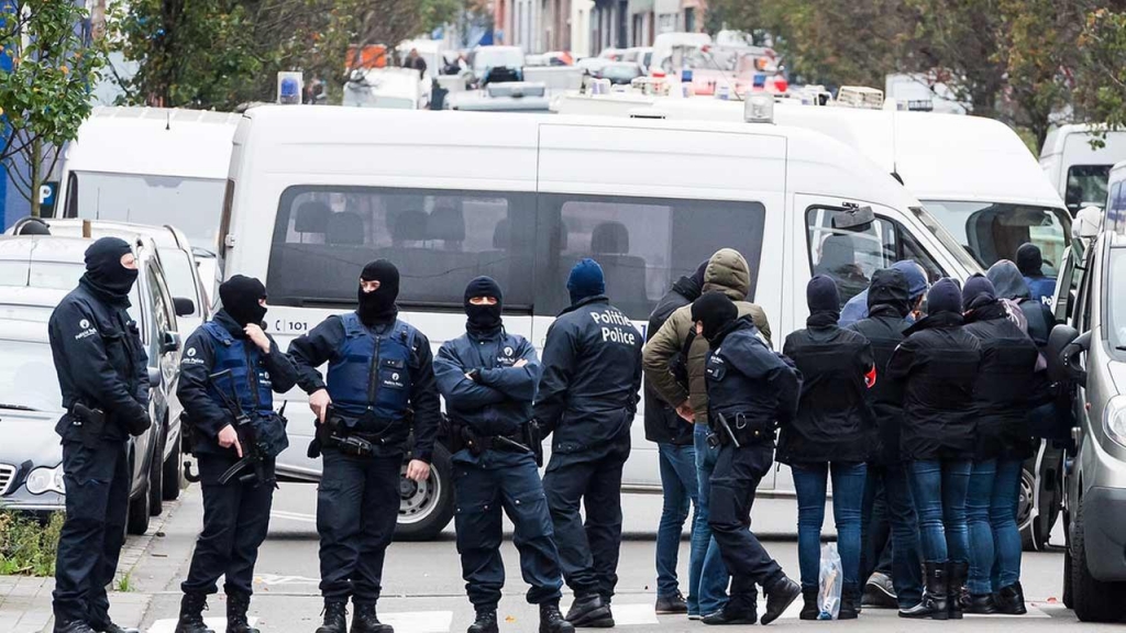 A major action with heavily armed police is underway Monday Nov. 16 2015 in the Brussels neighborhood of Molenbeek amid a manhunt for a suspect of the Paris attacks