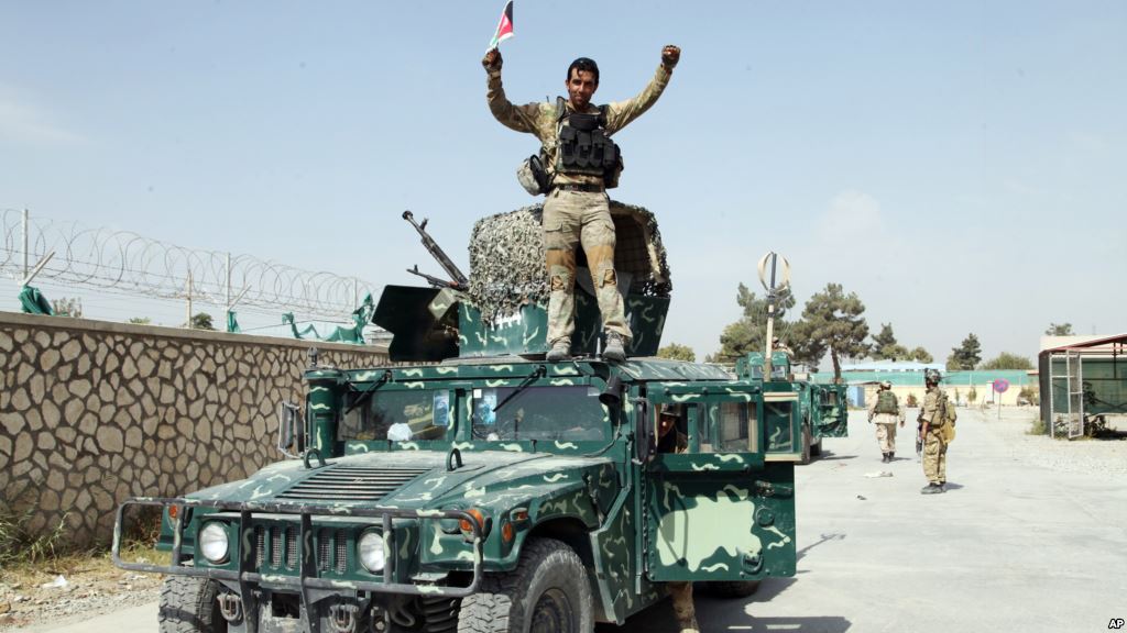 FILE- An Afghan soldier raises his hands as a victory sign after Kunduz was retaken from Taliban forces Oct. 2 2015