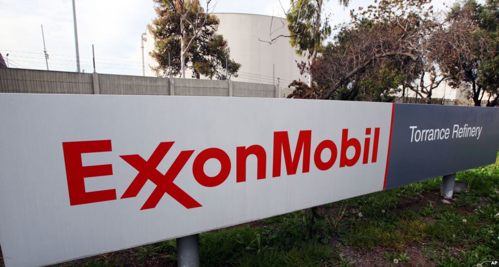 FILE- An Exxon Mobil sign sits outside a refinery in Torrance California