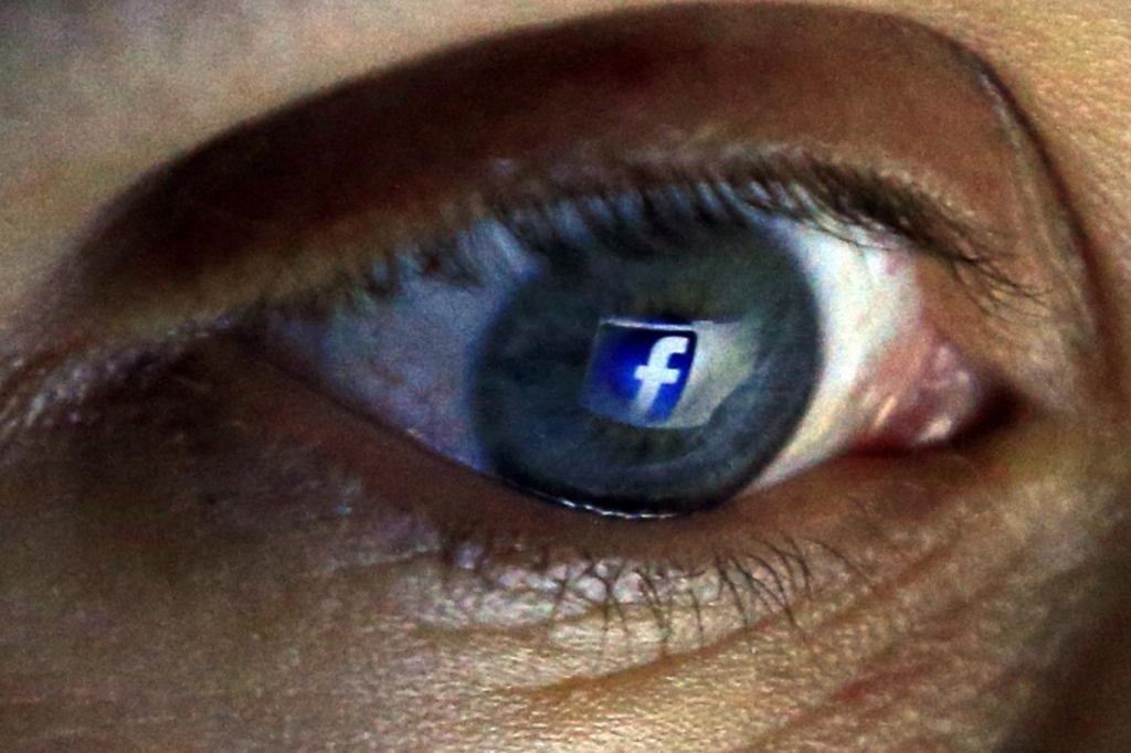 Facebook logo reflected in eye