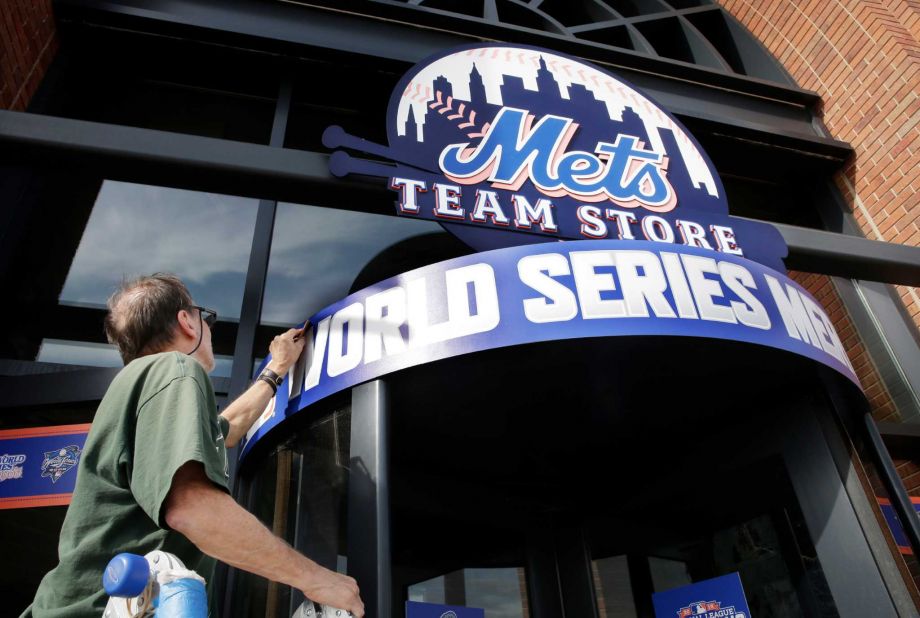 Joel Silva smooths a new World Series sign at Citi Field in New York Thursday Oct. 29 2015. The New York Mets are to face the Kansas City Royals in Game 3 of the World Series at the stadium on Friday