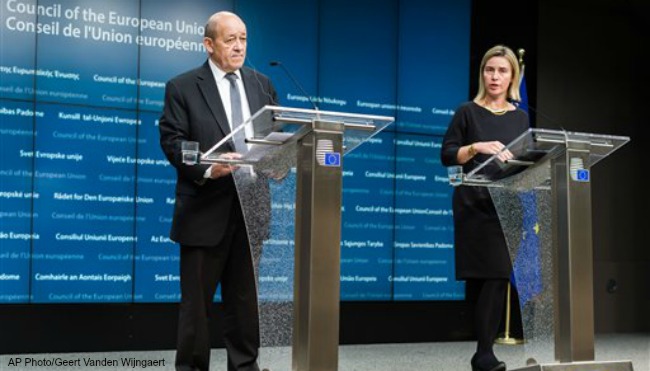 European Union High Representative for Foreign Affairs and Security Policy Federica Mogherini right and France's Defense Minister Jean Yves Le Drian address the media during an EU foreign and defense ministers meeting at the EU Council building