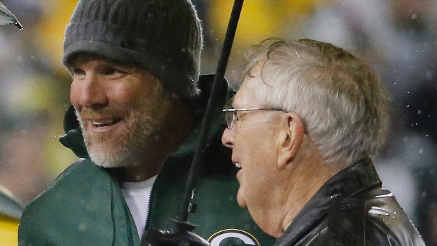 Brett Favre stands with former general manager Ron Wolf during a ceremony at halftime on Thursday in Green Bay Wis. Favre's retired No. 4 and name were unveiled inside Lambeau Field during the ceremony