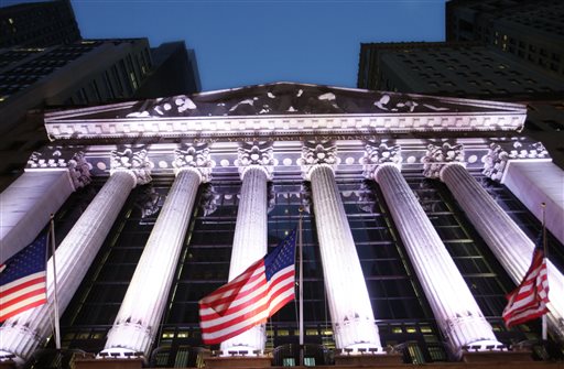 American flags fly in front of the New York Stock Exchange. Global shares rose on Wednesday Nov. 11 2015 as investors welcomed data that suggests China's economy is stabilizing. (AP