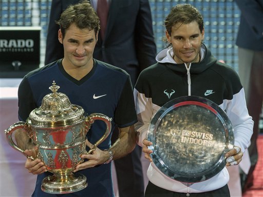 Switzerland's winner Roger Federer left and Spain's second placed Rafael Nadal right pose with their trophies after the final match of the Swiss Indoors tennis tournament at the St. Jakobshalle in Basel Switzerland Sunday Nov. 1 2015. (Georgios Ke