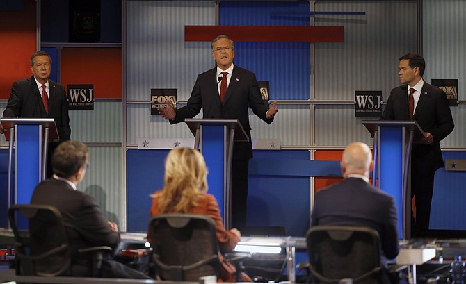 Jeb Bush speaks as John Kasich left and Marco Rubio listen during Republican presidential debate at Milwaukee Theatre Tuesday Nov. 10 2015 in Milwaukee