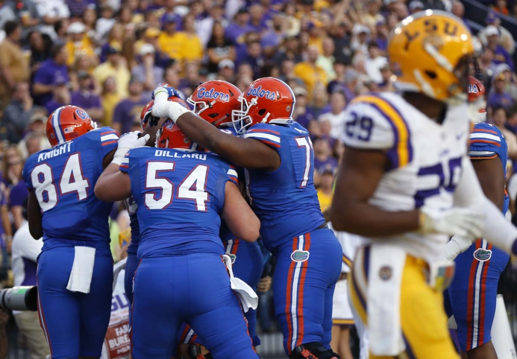 Florida tight end Jake Mc Gee is hugged by teammates after catching a touchdown pass in the first half of an NCAA college football game against LSU in Baton Rouge La. Saturday Oct. 17 2015