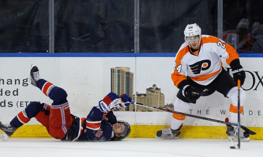 New York Rangers right wing Mats Zuccarello tries to pick the puck from Philadelphia Flyers right wing Matt Read after falling to the ice during the first period of an NHL hockey game Saturday Nov. 28 2015 in New York. (AP