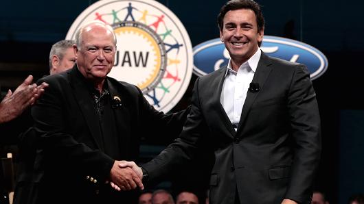 Dennis Williams president of the United Auto Workers, left shakes hands with Mark Fields president and chief executive officer of Ford Motor Co