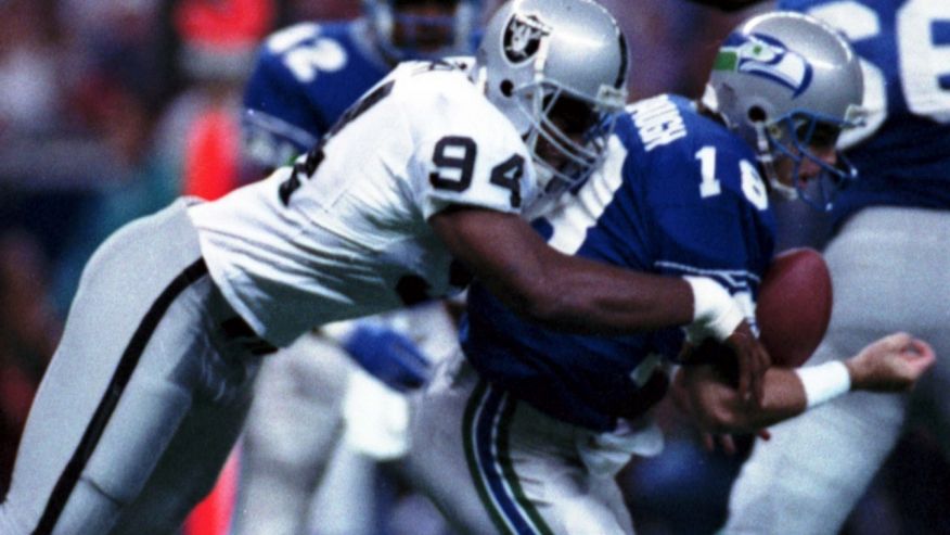 Los Angeles Raiders&#x27 Anthony Smith sacks Seattle Seahawks quarterback Stan Gelbaugh during the second quarter of an NFL football game in Seattle