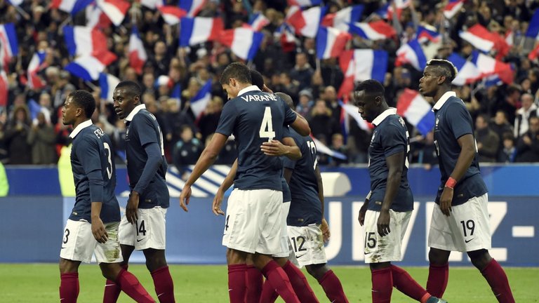 France's players celebrate after opening the scoring during the friendly against Germany