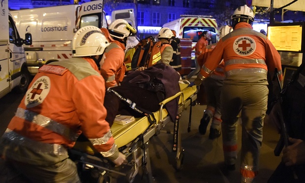 French Red Cross rescue workers evacuate an injured person near the Bataclan concert hall