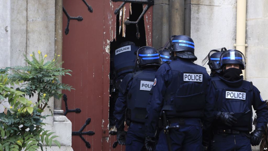 French police officers storm a church after a raid in Paris suburb Saint-Denis Nov. 18 2015