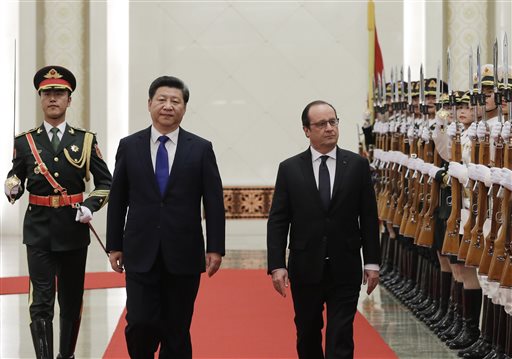 French President Francois Hollande right and Chinese President Xi Jinping second left review an honor guard during a welcome ceremony at the Great Hall of the People in Beijing China Monday Nov. 2 2015