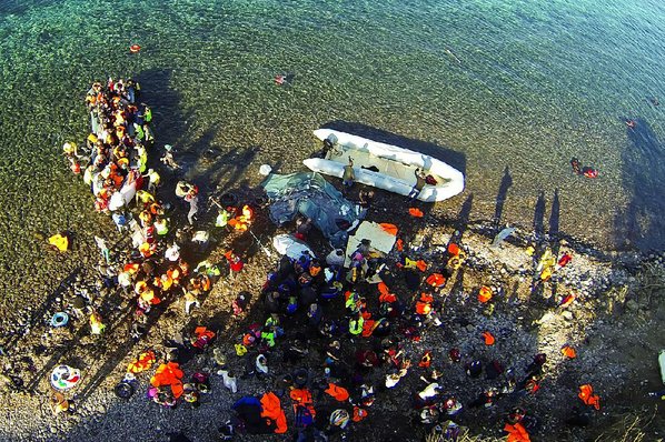 GIANNIS KOTSIARIS						Credit AP				Migrants land Friday on Lesbos in Greece after sailing from Turkey