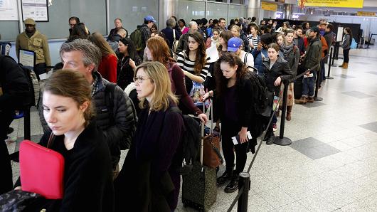 Travelers wait in line at a security checkpoint at New York's La Guardia Airport Nov. 25 2015