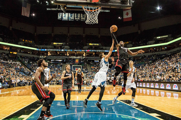 Miami Heat guard Dwyane Wade goes up for a layup past Minnesota Timberwolves guard Kevin Martin in the second half at Target Center. The Heat won 96-84