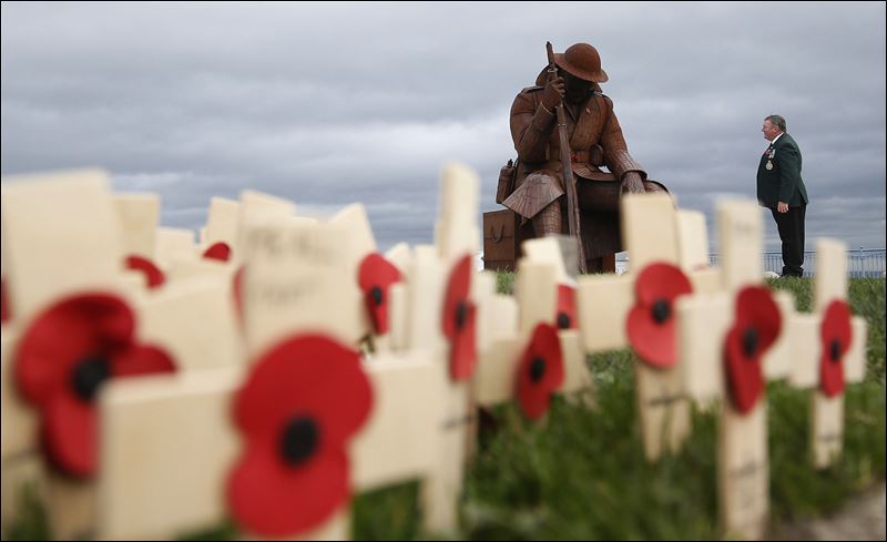 Larry Roberts 60 a veteran from South Shields in England who served with the Royal Green Jackets stands for a moment looking at the sculpture entitled Eleven 'O&#39 One in Seaham County Durham England ahead of playing the bugle during a ceremo