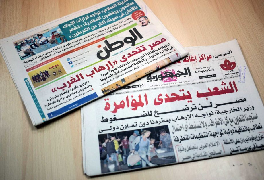 Two Egyptian daily newspapers from Sunday Nov. 8 2015 display headlines touting Western conspiracy theories in the plane crash of a Russian passenger jet last month over the Sinai peninsula. “The people defy the conspiracy- Egypt will not cave in