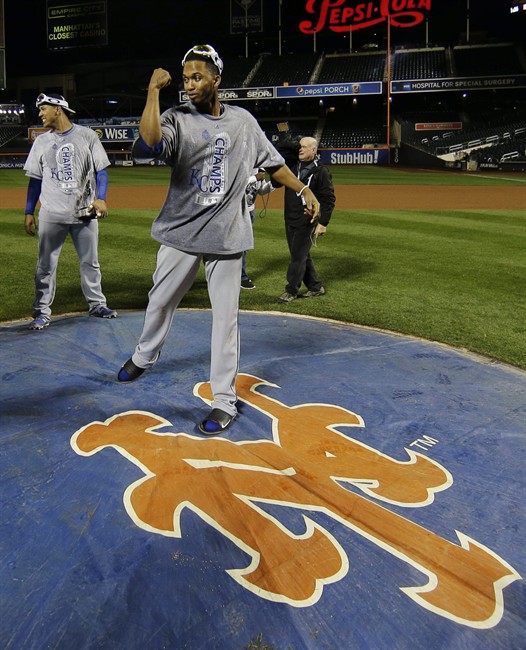 Kansas City Royals Alcides Escobar right poses on the New York Mets logo after Game 5 of the Major League Baseball World Series against the New York Mets Monday Nov. 2 2015 in New York. The Royals won 7-2 to win the series