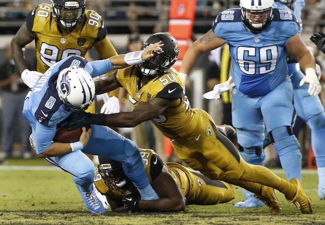 Titans quarterback Marcus Mariota is sacked by Jaguars defensive end Ryan Davis on Thursday