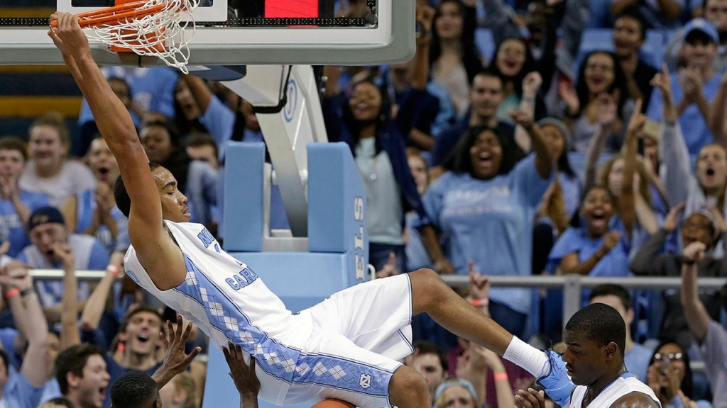 UNCs Brice Johnson dunks over Guilfords Justen Best as UNCs Joel James looks on during the second half of an NCAA college exhibition basketball game Friday Nov. 6 2015