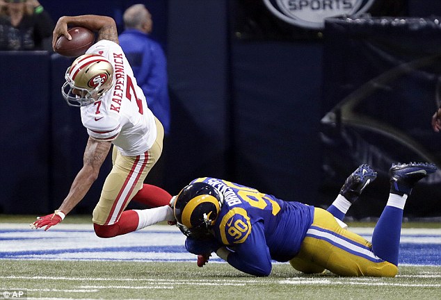 San Francisco 49ers quarterback Colin Kaepernick has reportedly lost his starting spot after the team's poor start to the season. Above he is sacked by Rams defensive tackle Michael Brockers on Sunday