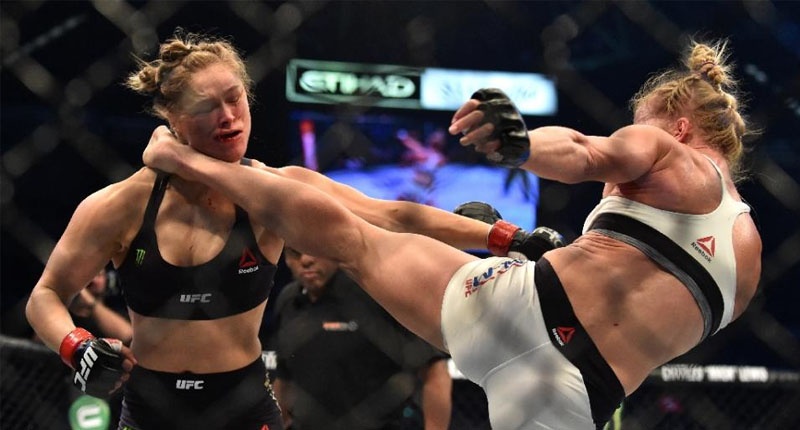 Holly Holm of the US lands a kick to the neck to knock out compatriot Ronda Rousey and win the UFC title fight in Melbourne