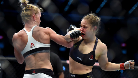 Holly Holm left and Ronda Rousey exchange their punches during their UFC 193 bantamweight title fight in Melbourne Australia