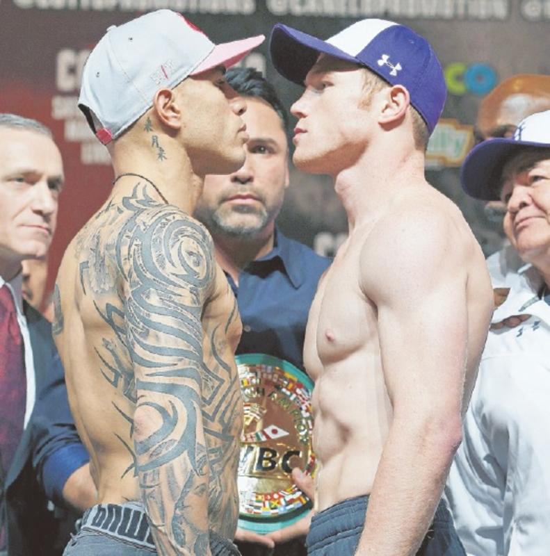 INTENSITY Miguel Cotto and Saul ‘Canelo’ Alvarez stare each other down yesterday before tonight’s middleweight bout in Las Vegas