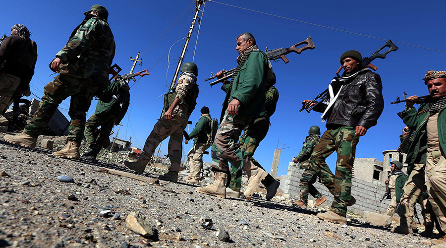 Iraqi autonomous Kurdish region's peshmerga forces and fighters from the Yazidi minority a local Kurdish-speaking community which the Islamic State group had brutally targeted in the area enter the northern Iraqi town of Sinjar in the Nineveh