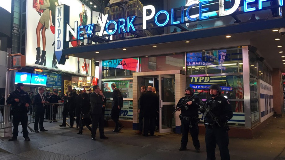 Police officers stand guard in Times Square Wednesday Nov. 18 2015 in New York. The New York Police Department says it's aware of a newly released Islamic State group video showing images of Times Square but says there's no current or specif