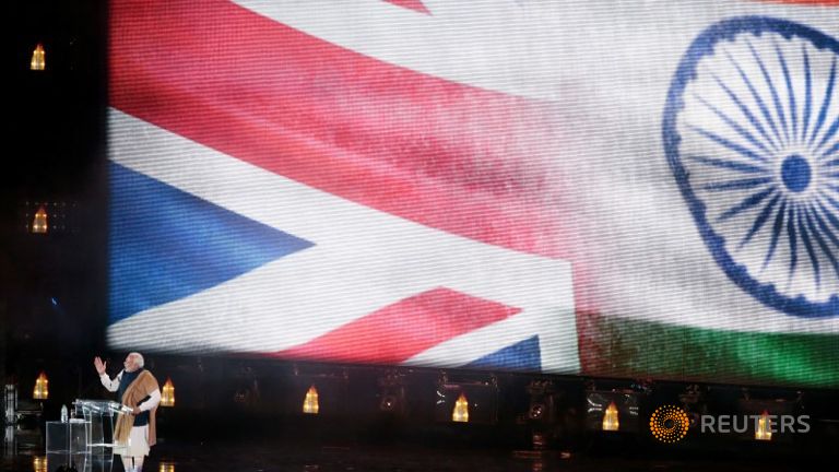 India's Prime Minister Narendra Modi stands on stage during an event at Wembley Stadium in London