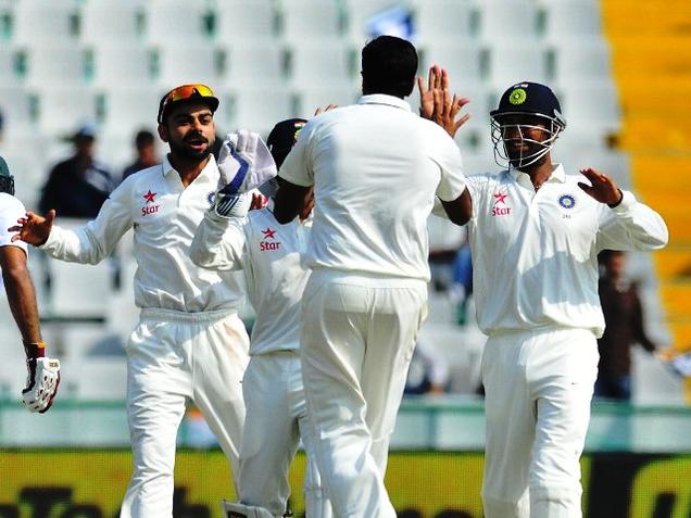 Virat Kohli and other players rush to greet Ashwin after a South African batsman dismissal in Mohali on Friday