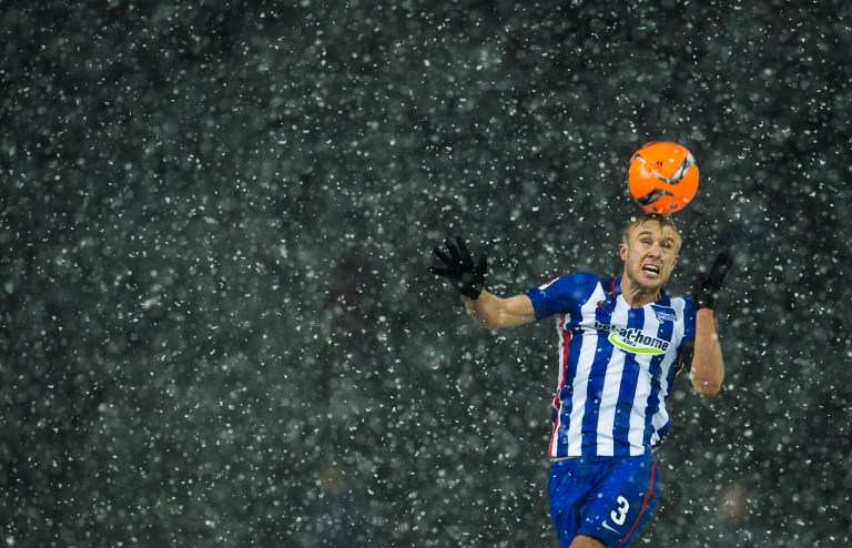 Hertha Berlin's Norwegian midfielder Per Skjelbred heads the ball in heavy snowfall during the German first division Bundesliga football match Hertha BSC Berlin vs TSG 1899 Hoffenheim at the Olympic Stadium in Berlin yesterday. – AFP pic