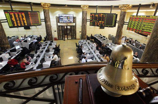 Egyptian traders work on the floor of the stock market in Cairo Egypt. Egypt's benchmark stock index plunged 4.4 percent on Tuesday Nov. 10 2015 after steadily declining since Russia suspended