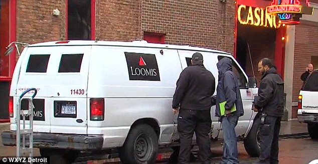 Investigators surround a Loomis security truck which saw $500,000 stolen from it by a man wearing a Loomis uniform