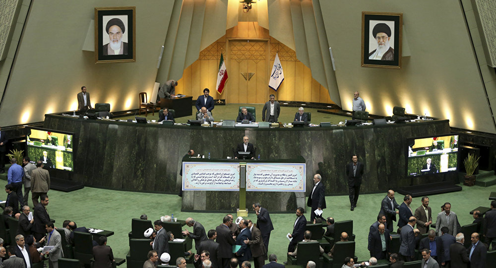 Head of Iran's Atomic Energy Organization Ali Akbar Salehi center speaks in an open session of parliament while discussing a bill on Iran's nuclear deal with world powers in Tehran