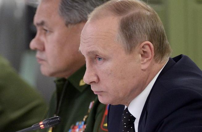 Russian President Vladimir Putin accompanied by Defence Minister Sergei Shoigu meets with top military officials in Moscow