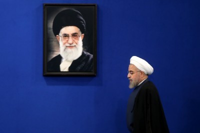 Iran’s President Hassan Rouhani walks past