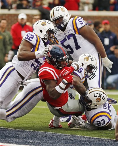 Mississippi running back Jaylen Walton stretches past LSU linebacker Kendell Beckwith for a 2-yard touchdown run in the first half of an NCAA college football game in Oxford Miss. Saturday Nov. 21 2015