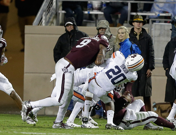 COLLEGE STATION TX- NOVEMBER 07 Jeremiah Dinson #20 of the Auburn Tigers takes a hard hit from Ricky Seals Jones #9 of the Texas A&M Aggies in the fourth quarter at Kyle Field