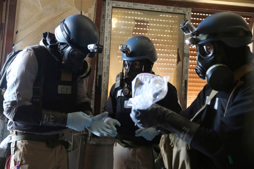 Image A U.N. chemical weapons expert holds a plastic bag containing samples from one of the sites of an alleged chemical weapons attack in Ain Tarma