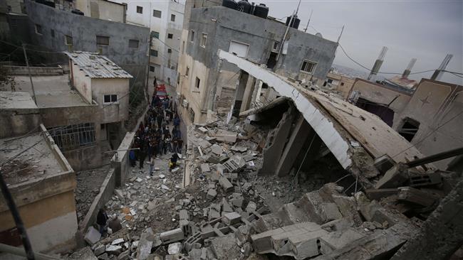 Onlookers gather near a house demolished by Israeli troops at Qalandia refugee camp in the Israeli-occupied occupied West Bank