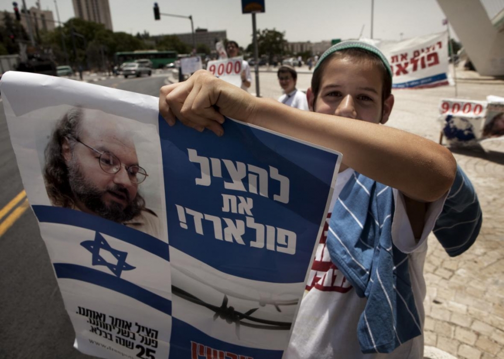 102843320-an-israeli-youth-demonstrator-holds-a